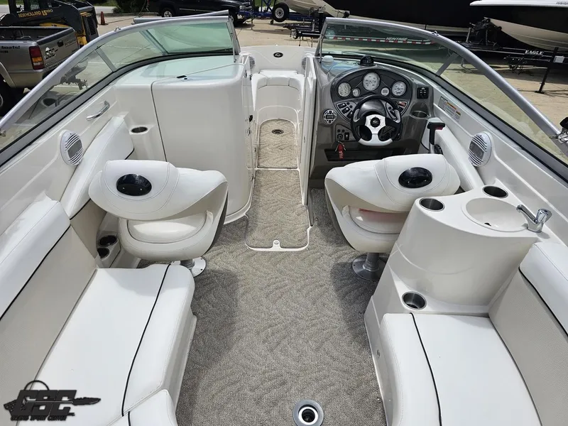 Slide: The Image of 2007 Rinker 246 Captiva Bowrider interior with white seating and modern dashboard. - 45