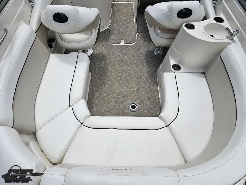 Slide: The Image of 2007 Rinker 246 Captiva Bowrider interior with white seating and carpeted floor. - 46