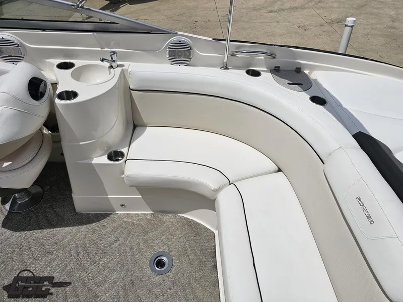Slide: The Image of 2007 Rinker 246 Captiva Bowrider interior with white seating and cup holders. - 48