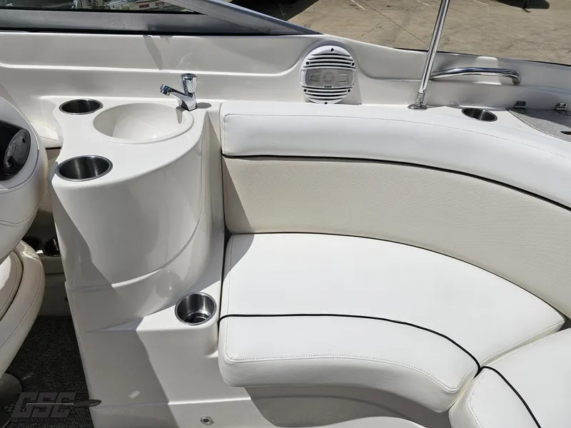 Slide: The Image of 2007 Rinker 246 Captiva Bowrider interior with white seating, cup holders, and a small sink. - 49
