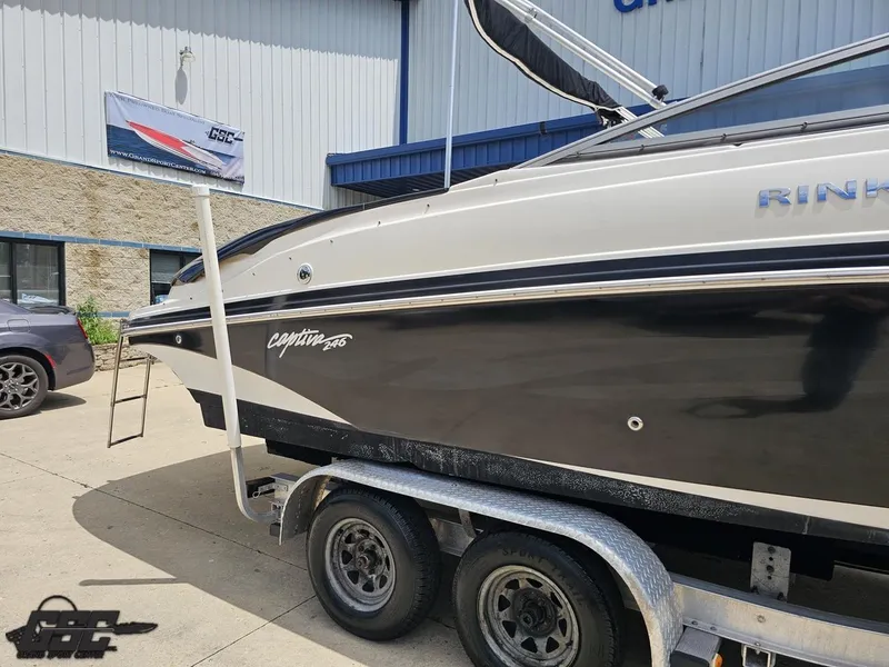 Slide: The Image of 2007 Rinker 246 Captiva Bowrider on trailer outside a building. - 5
