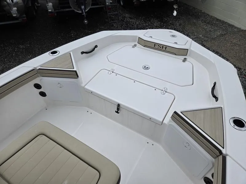 Slide: The Image of 2022 Yamaha Boats 195 FSH® SPORT interior, featuring seating and storage compartments. - 12