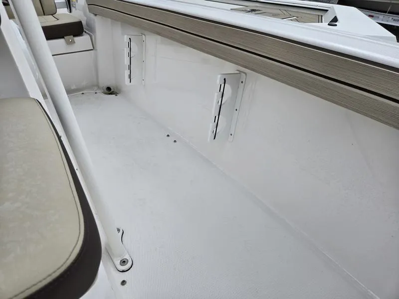 Slide: The Image of 2022 Yamaha Boats 195 FSH® SPORT interior, featuring white deck and cushioned seating. - 19