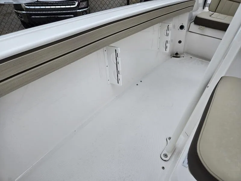 Slide: The Image of 2022 Yamaha Boats 195 FSH® SPORT interior, featuring white deck and seating area. - 21