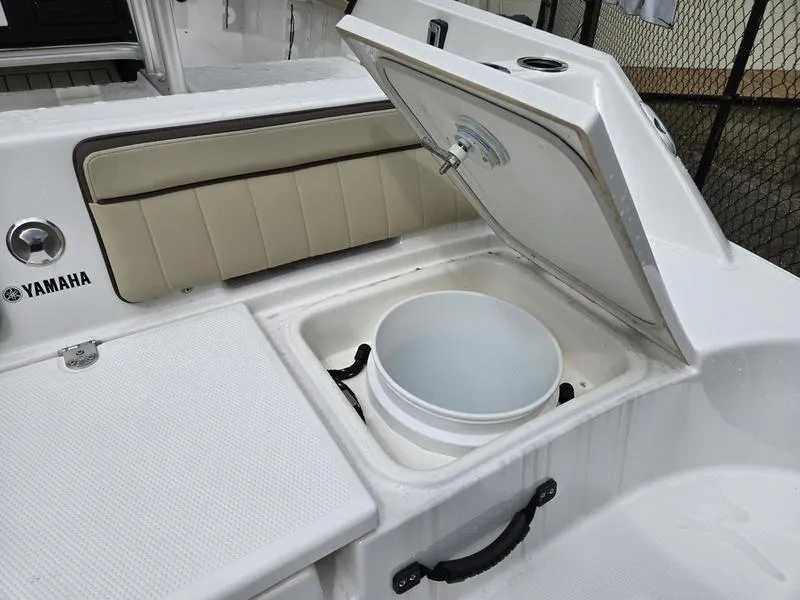 Slide: The Image of 2022 Yamaha Boats 195 FSH® SPORT with open storage compartment and bucket. - 7