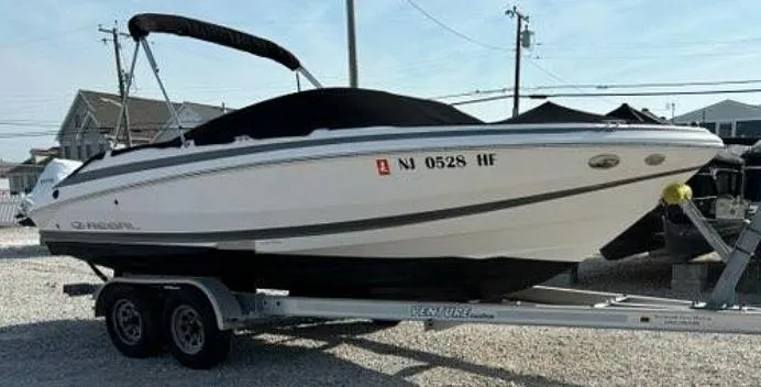 Slide: The Image of 2013 Regal 2000 ES boat on trailer, parked outdoors, with cover and visible registration number. - 9
