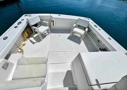Slide: The Image of 2003 Pursuit 3400 Express boat deck with chairs, storage, and ocean view. - 11