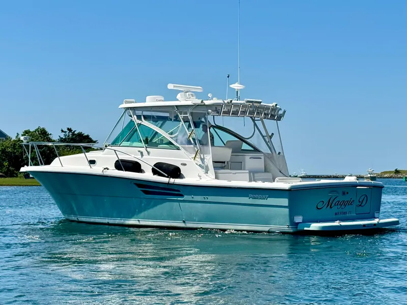 Slide: The Image of 2003 Pursuit 3400 Express boat on calm water, clear sky background. - 5
