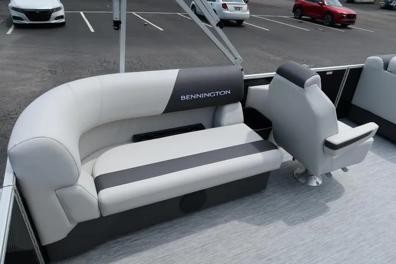 Slide: The Image of 2026 Bennington S Quad Bench 20 SSR boat dashboard with steering wheel and controls. - 11
