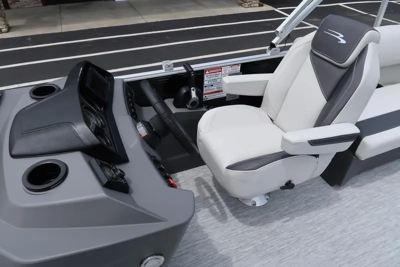 Slide: The Image of 2026 Bennington S Quad Bench 20 SSR interior with steering console and seating. - 14