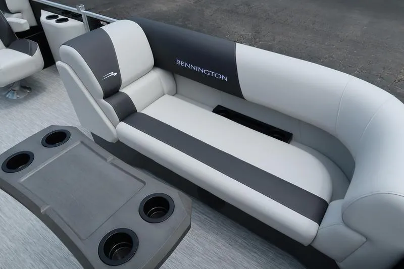 Slide: The Image of 2026 Bennington S Quad Bench 20 SSR pontoon boat interior with gray seating and steering console. - 18