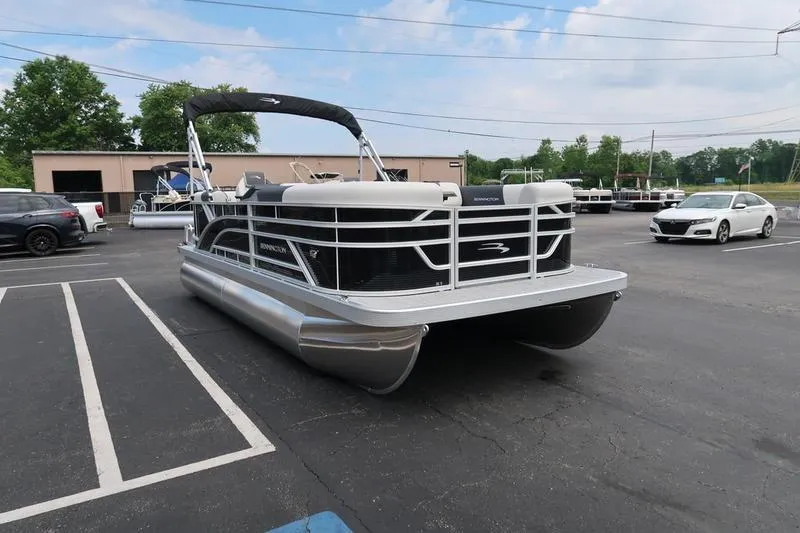 Slide: The Image of 2026 Bennington S Quad Bench 20 SSR pontoon boat in a parking lot. - 5