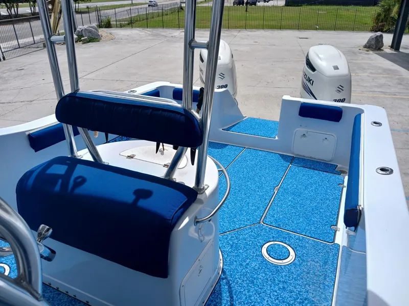 Slide: The Image of 2002 ProKat 2860 Center Console boat with blue seating and twin Suzuki engines. - 10