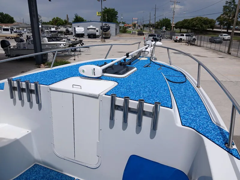 Slide: The Image of 2002 ProKat 2860 Center Console boat with blue deck, docked in a marina. - 11