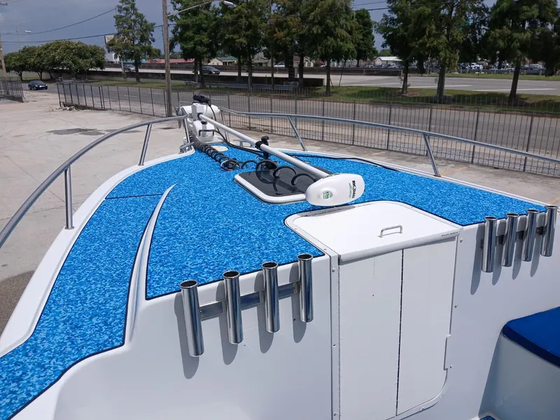 Slide: The Image of 2002 ProKat 2860 Center Console boat with blue deck and rod holders. - 12