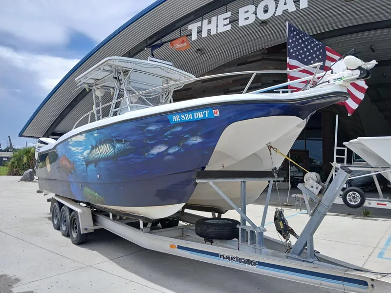Slide: The Image of 2002 ProKat 2860 Center Console boat on trailer, featuring marine-themed hull artwork. - 14