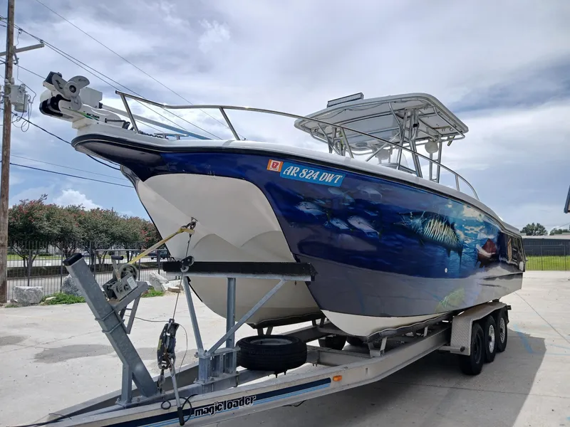 Slide: The Image of 2002 ProKat 2860 Center Console boat on trailer, featuring marine-themed hull artwork. - 15