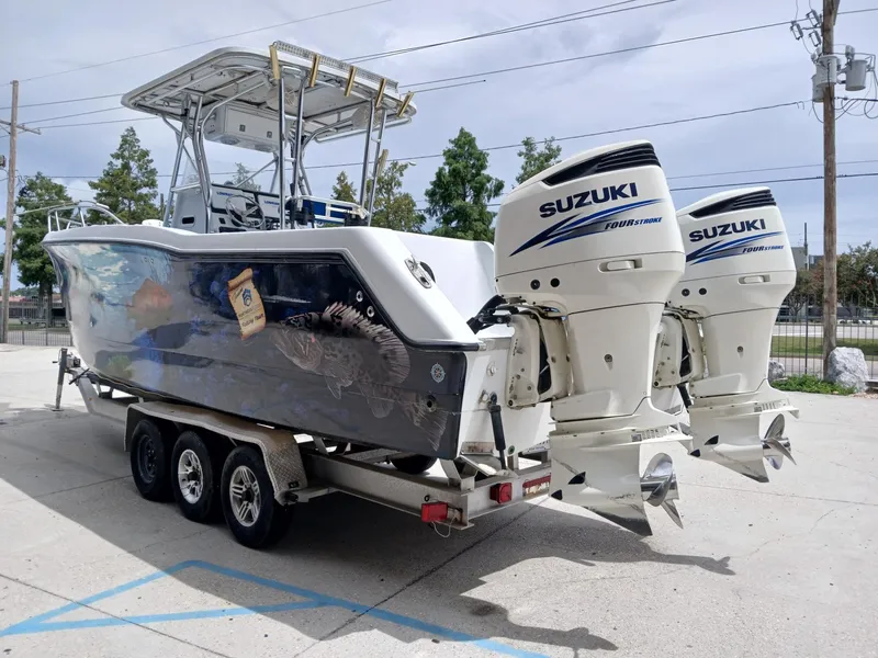 Slide: The Image of 2002 ProKat 2860 Center Console boat with twin Suzuki outboard motors on a trailer. - 16