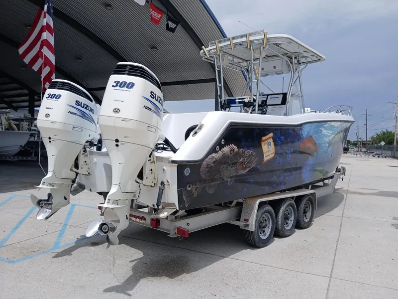 Slide: The Image of 2002 ProKat 2860 Center Console boat with dual Suzuki 300 engines, vibrant marine graphics. - 17