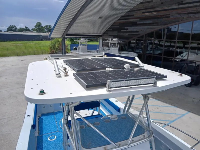 Slide: The Image of 2002 ProKat 2860 Center Console with solar panels on the roof, docked outdoors. - 3