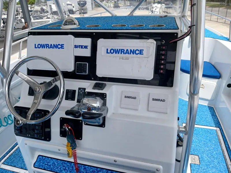 Slide: The Image of 2002 ProKat 2860 Center Console boat dashboard with Lowrance and Simrad equipment. - 8