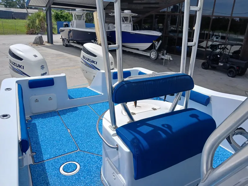 Slide: The Image of 2002 ProKat 2860 Center Console boat with Suzuki engines, blue seating, and deck. - 9