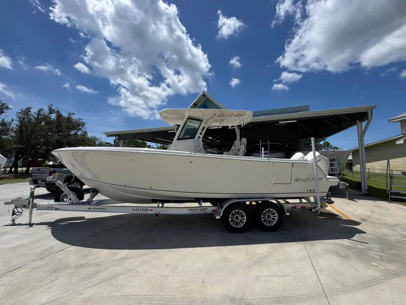 The Image of 2026 Sailfish 272 CC boat on trailer under clear blue sky. - 1