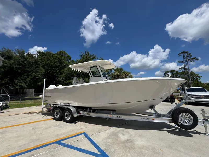 Slide: The Image of 2026 Sailfish 272 CC boat on trailer under clear blue sky. - 10