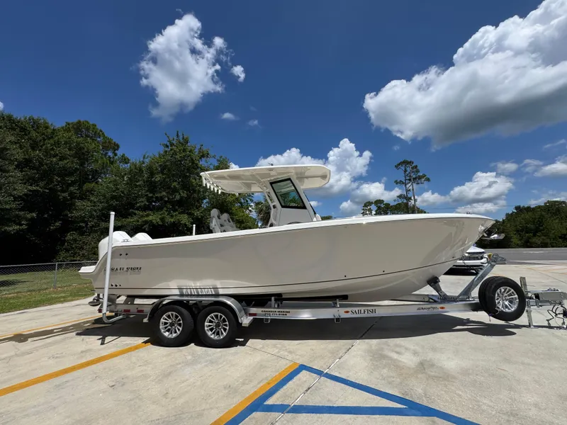 Slide: The Image of 2026 Sailfish 272 CC boat on trailer under blue sky with clouds. - 11