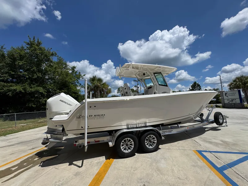 Slide: The Image of 2026 Sailfish 272 CC boat on trailer under blue sky with clouds. - 13