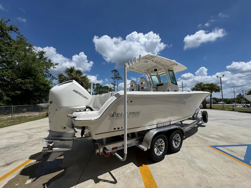 Slide: The Image of 2026 Sailfish 272 CC boat on trailer under clear blue sky. - 14