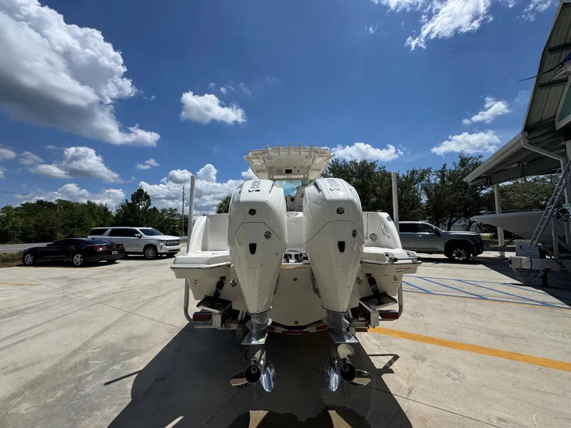 Slide: The Image of 2026 Sailfish 272 CC boat with dual engines parked outdoors under a clear blue sky. - 18