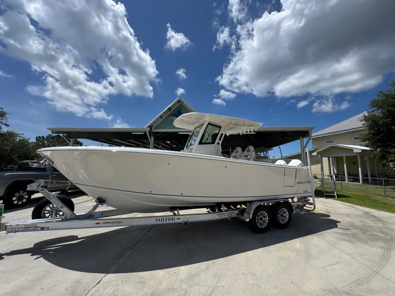 Slide: The Image of 2026 Sailfish 272 CC boat on trailer under blue sky with clouds. - 2