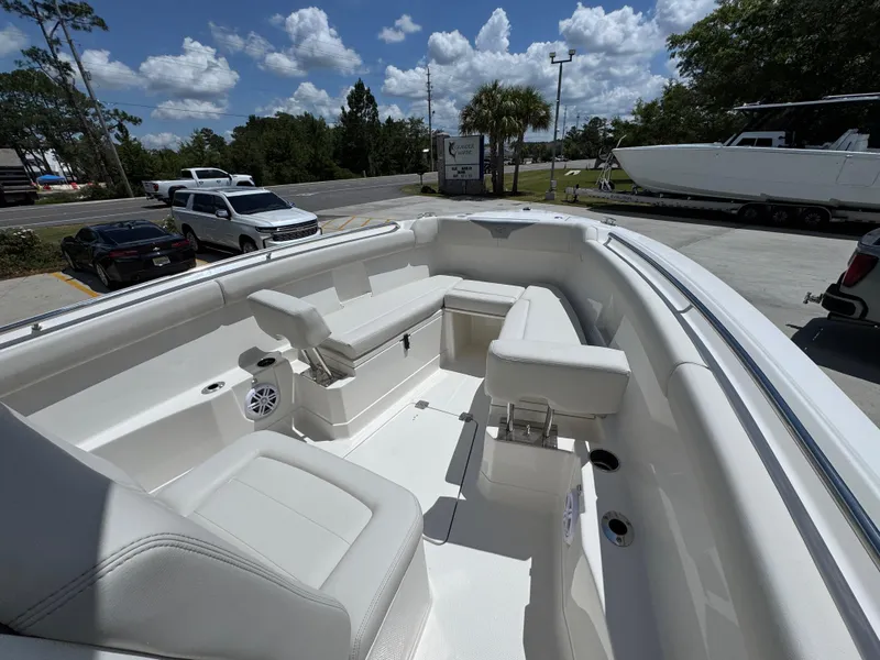 Slide: The Image of 2026 Sailfish 272 CC boat interior with white seating and clear sky background. - 22
