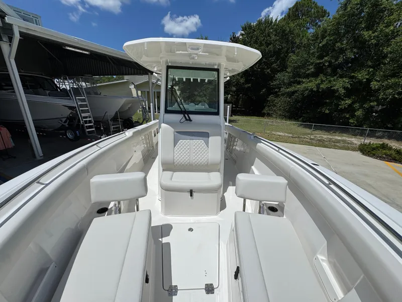 Slide: The Image of 2026 Sailfish 272 CC boat interior with seating, under a clear blue sky. - 27