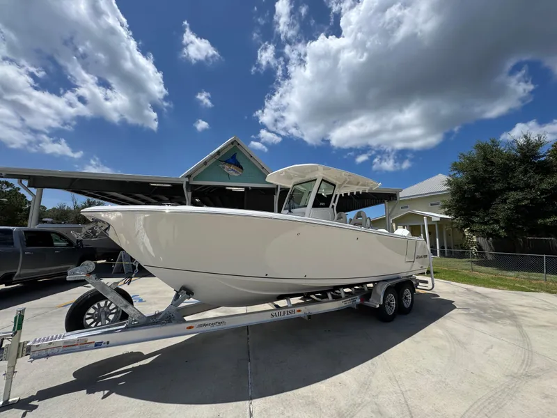 Slide: The Image of 2026 Sailfish 272 CC boat on trailer under a blue sky with clouds. - 3