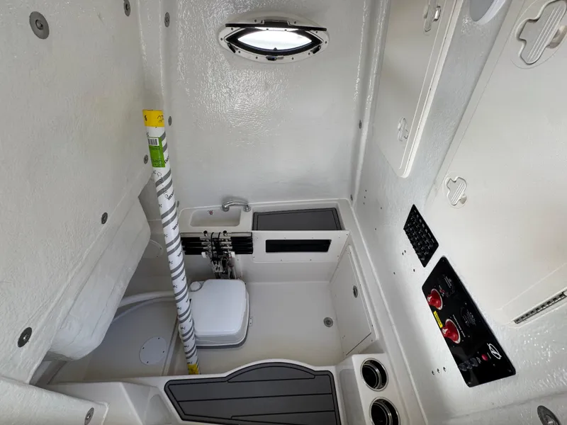 Slide: The Image of Interior of 2026 Sailfish 272 CC boat, featuring compact bathroom and control panel. - 30