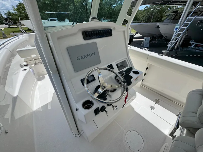 Slide: The Image of 2026 Sailfish 272 CC boat console with Garmin navigation system and steering wheel. - 33