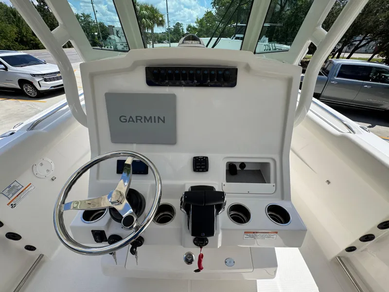 Slide: The Image of 2026 Sailfish 272 CC boat helm with Garmin display and steering wheel. - 34
