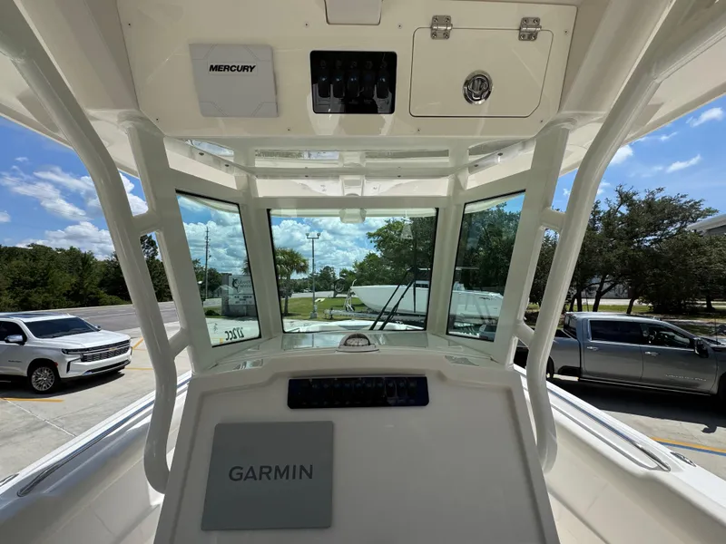 Slide: The Image of 2026 Sailfish 272 CC boat cockpit with Garmin and Mercury equipment, parked outdoors. - 35