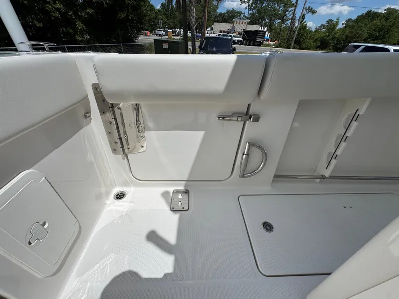 Slide: The Image of Interior view of 2026 Sailfish 272 CC boat, featuring sleek white seating and storage compartments. - 38