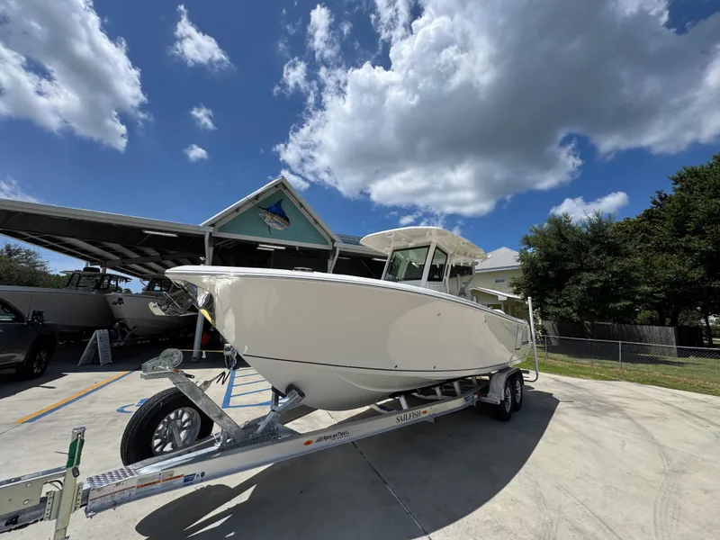 Slide: The Image of 2026 Sailfish 272 CC boat on trailer under blue sky with clouds. - 4