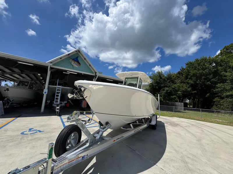 Slide: The Image of 2026 Sailfish 272 CC boat on trailer under blue sky near storage facility. - 5