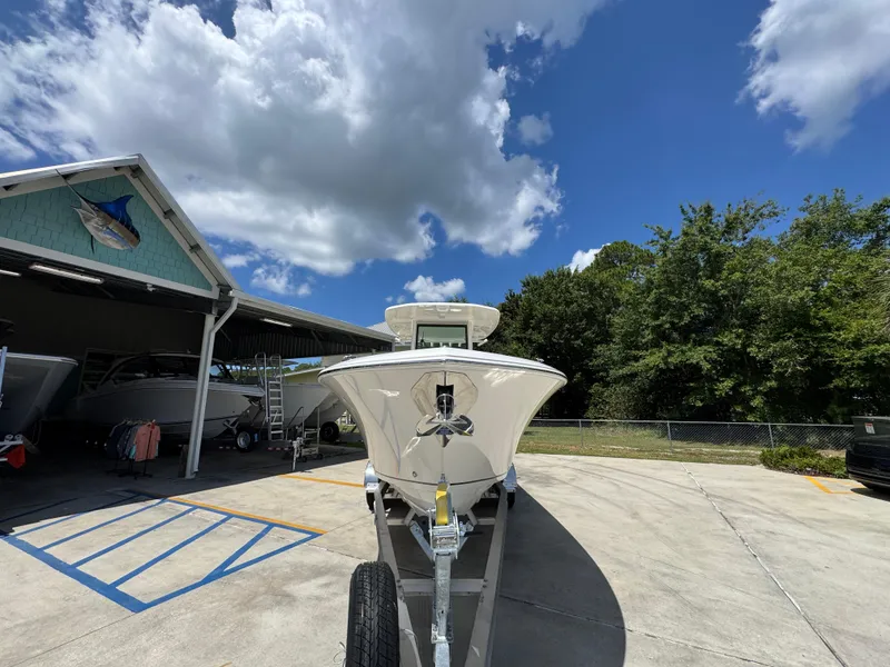 Slide: The Image of 2026 Sailfish 272 CC boat on trailer under blue sky, near storage facility. - 7