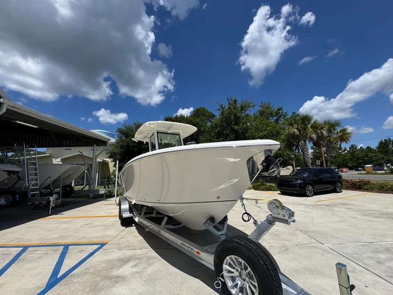 Slide: The Image of 2026 Sailfish 272 CC boat on trailer under blue sky with clouds. - 8