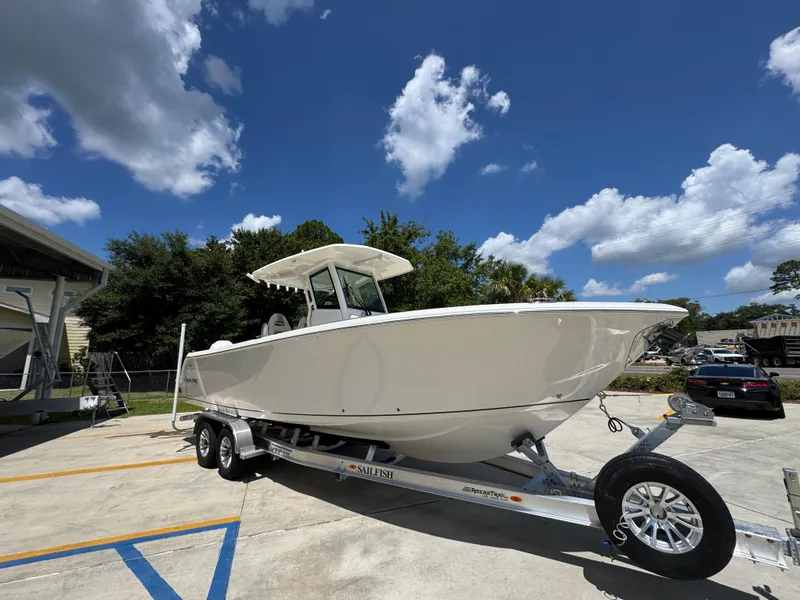 Slide: The Image of 2026 Sailfish 272 CC boat on trailer under blue sky with clouds. - 9