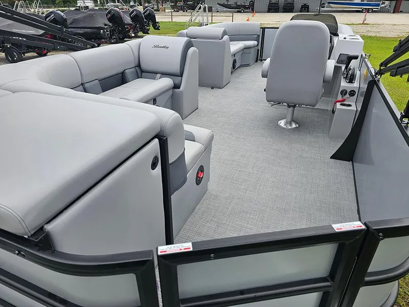 Slide: The Image of 2026 Bentley Pontoons Legacy 243 Cruise on grass, showcasing sleek design and modern features. - 10