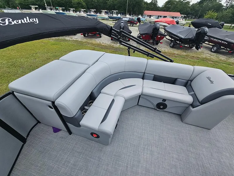 Slide: The Image of 2026 Bentley Pontoons Legacy 243 Cruise pontoon boat with ladder on grassy area. - 11