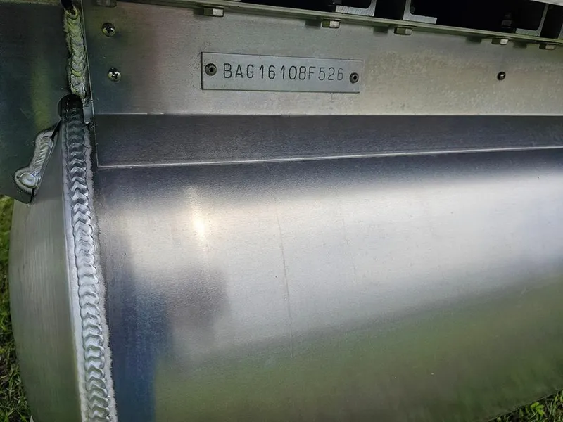 Slide: The Image of Close-up of 2026 Bentley Pontoons Legacy 243 Cruise metal hull with serial number. - 26