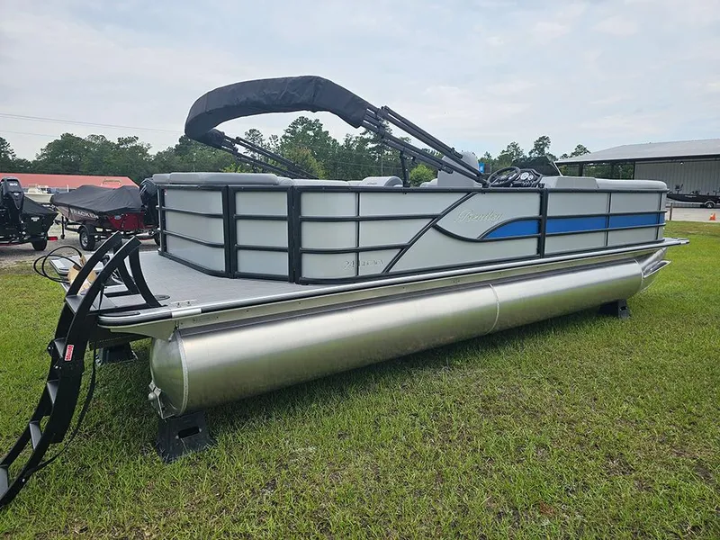 Slide: The Image of 2026 Bentley Pontoons Legacy 243 Cruise on grass, rear view with outboard motor. - 3